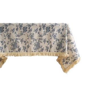 Linen cotton tablecloth with blue floral pattern and elegant beige fringe trim details