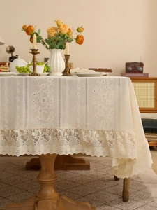 Detail of vintage lace tablecloth with floral embroidery and elegant ruffled edges