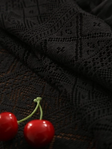 Macro shot of black retro lace tablecloth showing delicate knit diamond镂空 details