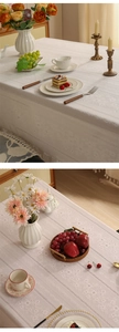 Detailed macro view showing lace jacquard patterns and hollowed ribbons on the cream tablecloth