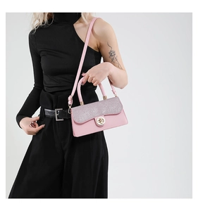 Pink woven crossbody bag with silver sequin flap and golden metal clasp on model