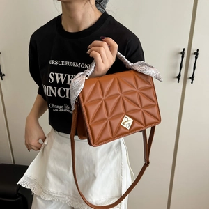 Brown quilted crossbody bag with golden buckle and stylish silk scarf wrapped handle