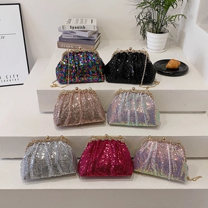 Sparkly mermaid sequin clutch bag set with gold chains displayed on white steps