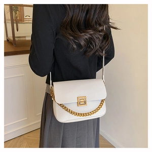 Detail of white lychee grain leather handbag with gold metal clasp and chunky chain