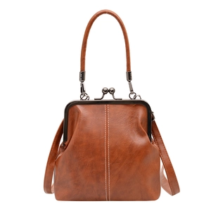 Vintage caramel leather handbag with white stitching and metal clasp for formal occasions