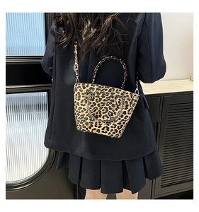 Dettaglio posteriore della borsa leopardata con tracolla regolabile e piedini metallici