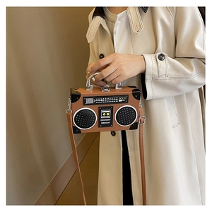 Detailed view of creative vintage radio shaped shoulder bag with metallic handle