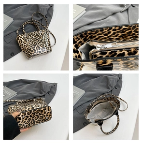 Detail view of leopard print handbag showing hardware, base studs, and interior space