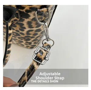 Close-up of adjustable strap with metallic lobster clasp on leopard print tote bag