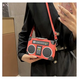 Macro detail of red vintage radio-shaped crossbody bag with realistic dial and PU texture
