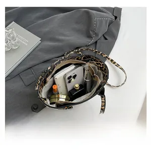 Detailed interior of leopard print bucket bag showing storage space for daily essentials