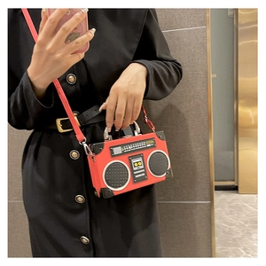 Detail of vintage radio shape crossbody bag with retro tuner dial and BOOM logo