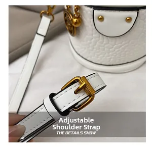 Detail of adjustable white leather strap with premium gold metal buckle and hardware