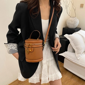 Vintage caramel brown crocodile pattern bucket bag with golden hardware and leather strap