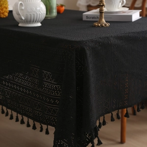Black hollow lace tablecloth with elegant floral patterns and vintage fringe tassel edges