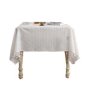 White hollow lace tablecloth with geometric patterns and fringe tassels for dining tables