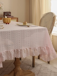 Detailed view of pink floral lace tablecloth with elegant scalloped ruffled edges