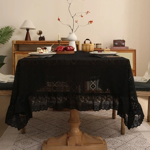 Elegant black lace tablecloth with geometric hollow patterns and ruffled edges for Nordic decor