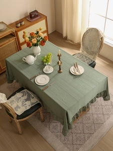 Close-up of Morandi green vintage tablecloth with floral embroidery and lace borders