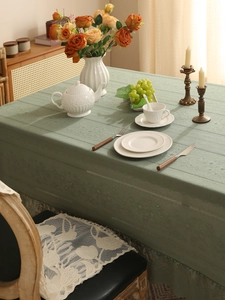 Detailed sage green lace tablecloth with knitted texture and elegant hollow patterns