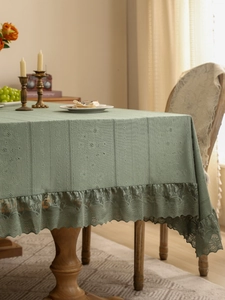 Sage green vintage tablecloth with vertical texture and elegant lace border detail