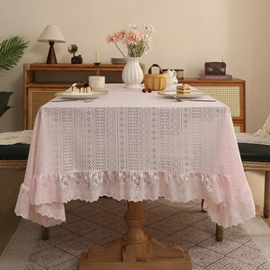 Pink vintage lace tablecloth with elegant ruffled edges for a romantic home dining decor