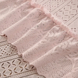 Light pink vintage lace tablecloth featuring ruffled edges and floral hollow patterns