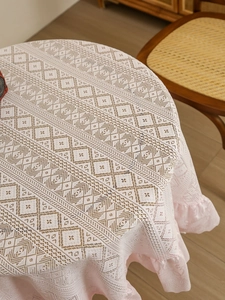 Close-up of vintage lace tablecloth showing intricate ruffle edges and diamond weave pattern