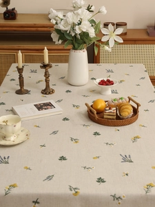 Close-up of premium linen tablecloth with elegant lavender and floral embroidery patterns