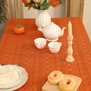 Orange lace tablecloth with geometric hollow patterns for a vintage home dining setting