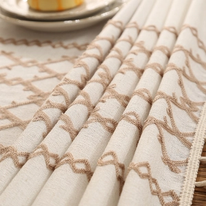 Beige linen tablecloth with geometric chain embroidery and elegant fringe tassels