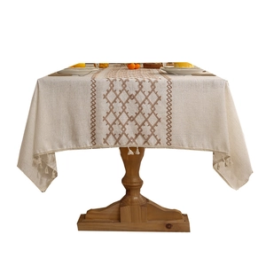 Linen textured beige tablecloth with diamond embroidery and elegant edge tassels