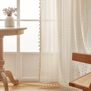 Detail of American vintage lace curtain with floral patterns and delicate fringe edge trim
