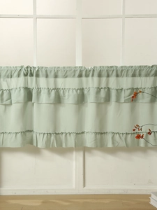 Detail of light green cafe curtain featuring triple-layered ruffles and rod pocket design