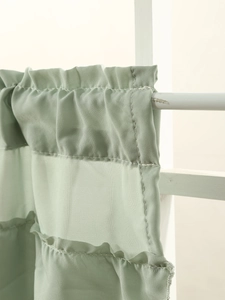 Detailed close-up of light green sheer cafe curtain with ruffled rod pocket design