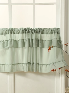 Close-up of light green ruffled cafe curtain with semi-sheer fabric and rod pocket design