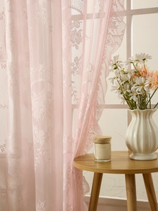 Macro detail of soft pink floral lace curtain with damask embroidery for living room