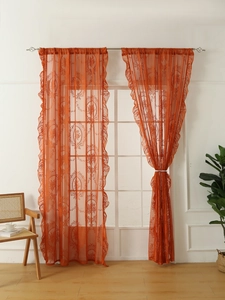 Detail of orange lace floral curtains with elegant ruffles and rod pocket design