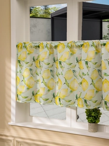 Detail of light green short curtain with lemon pattern and fine fabric texture