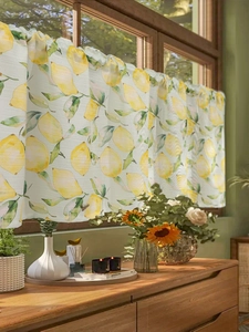 Detail of fabric half-curtain with fresh lemon print and natural sunlight effect