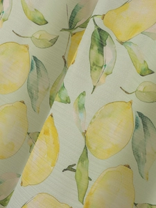 Macro view of light fabric showing lemon prints and fine mesh texture with soft drape