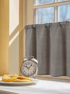 Detail of black and white gingham fabric texture on a short kitchen cafe curtain