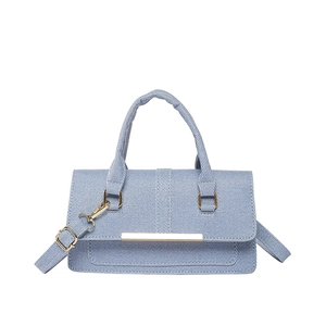 Light blue denim handbag with gold hardware and removable strap on white background
