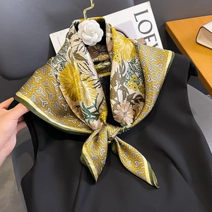 Silk scarf with yellow chrysanthemum floral print and geometric pattern on a black top