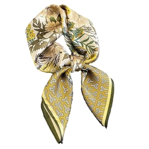 Elegant silk square scarf with yellow floral and geometric patterns in a bowtie knot