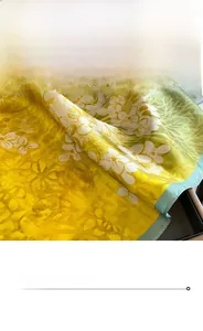 Detail of floral oil painting silk scarf showing premium stitching and satin texture