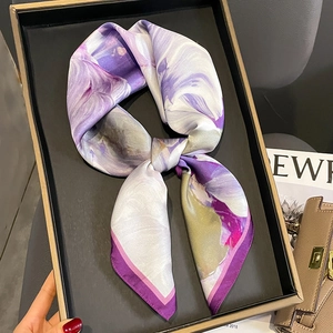 Silk square scarf with purple marble print and dark borders on black tray display