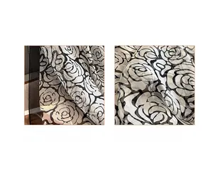 Detailed close-up of neat stitched edges and camellia floral print on the silk scarf