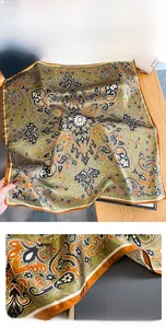 Detail of dark green mulberry silk scarf featuring Persian patterns and reinforced edges