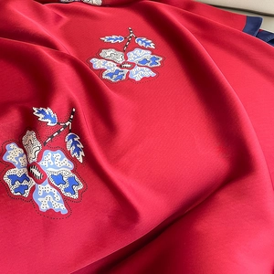 Elegant red silk scarf with blue floral prints and smooth satin finish for women